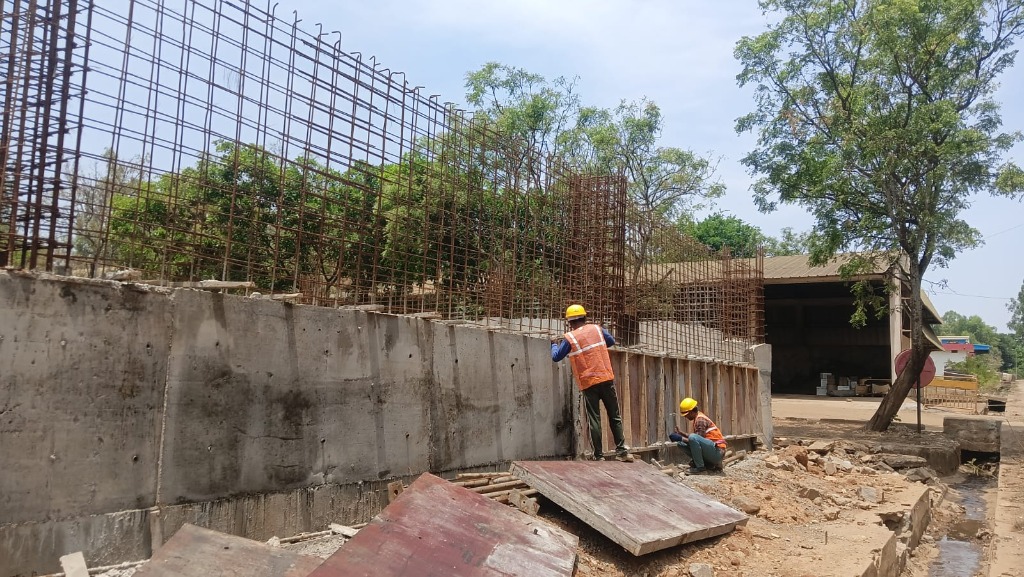 Cast reinforced concrete wall section with top rebar mesh and shuttering formwork alignment
