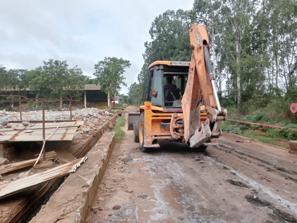 JCB Backhoe Loader performing foundation trench excavation at Dobbaspet