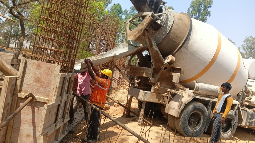 Transit concrete mixer pouring concrete into 12-inch RC wall shuttering formwork